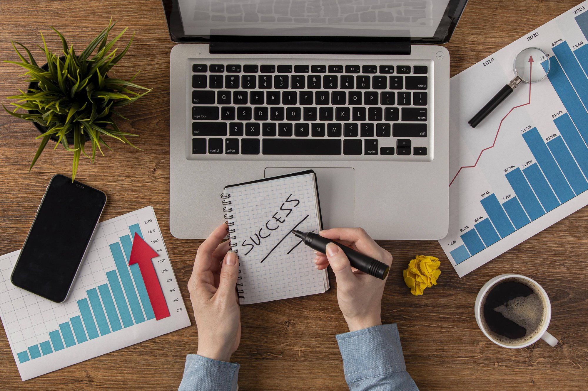 top-view-office-desk-with-laptop-growth-chart